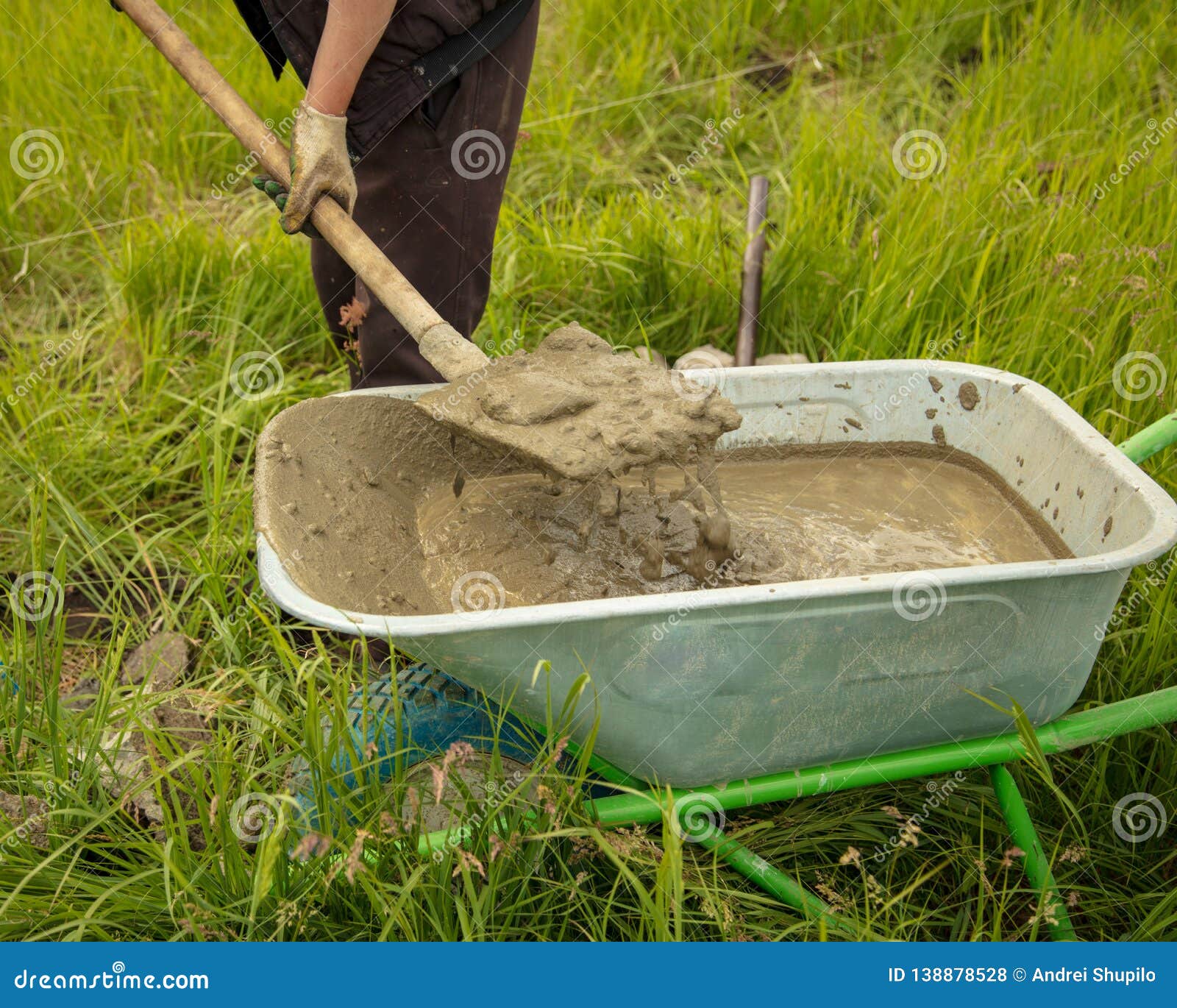 Mixture of Concrete in a Wheelbarrow at a Construction Site Stock Photo