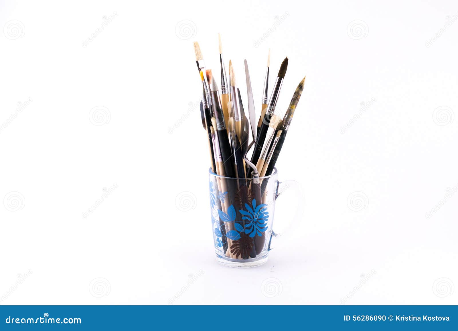 Mixture of Different Kinds and Sizes of Brushes and Spatula on a White