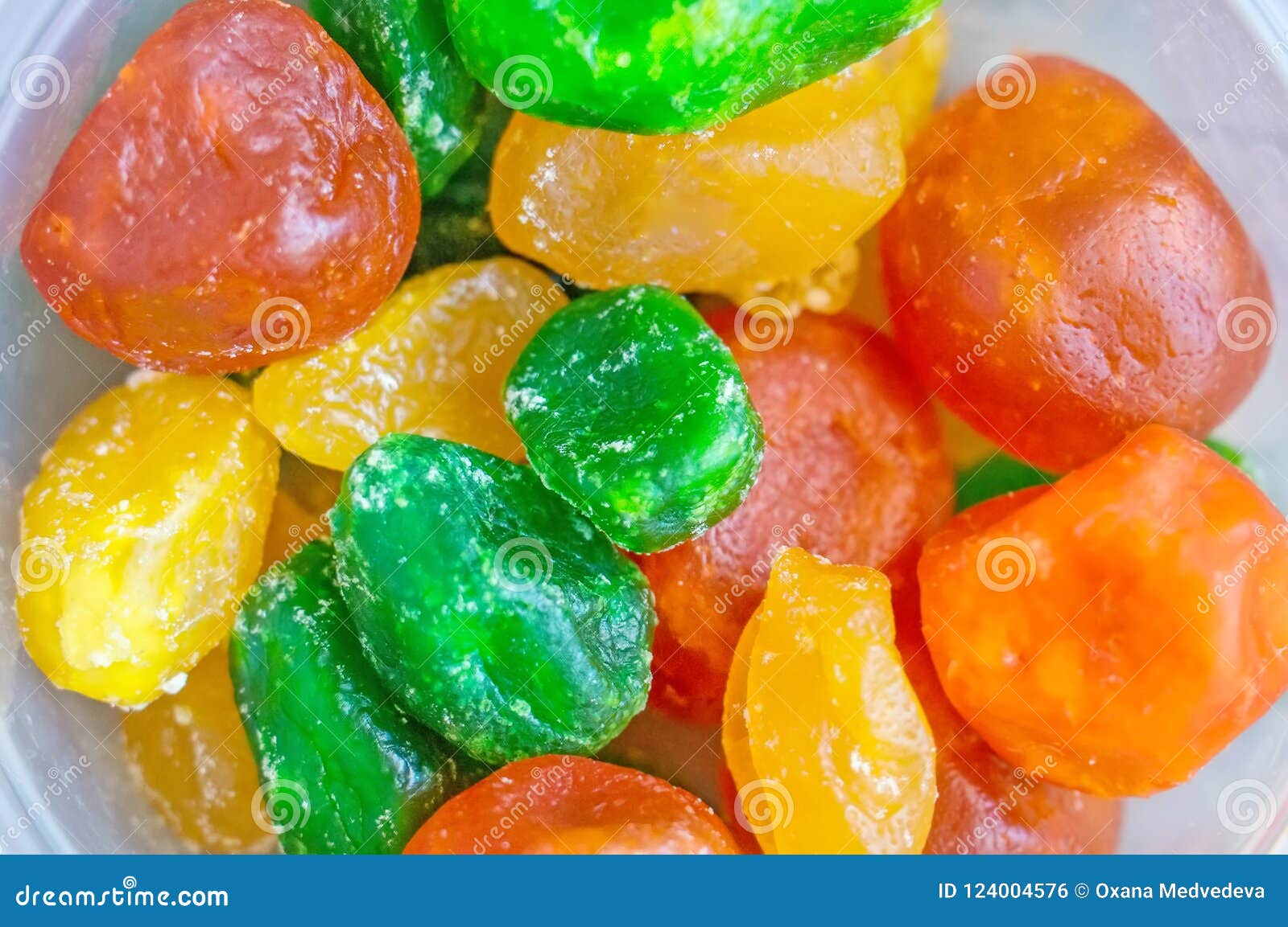 A Mixture of Multicolored Dried Kumquats on a Plate. Stock Photo