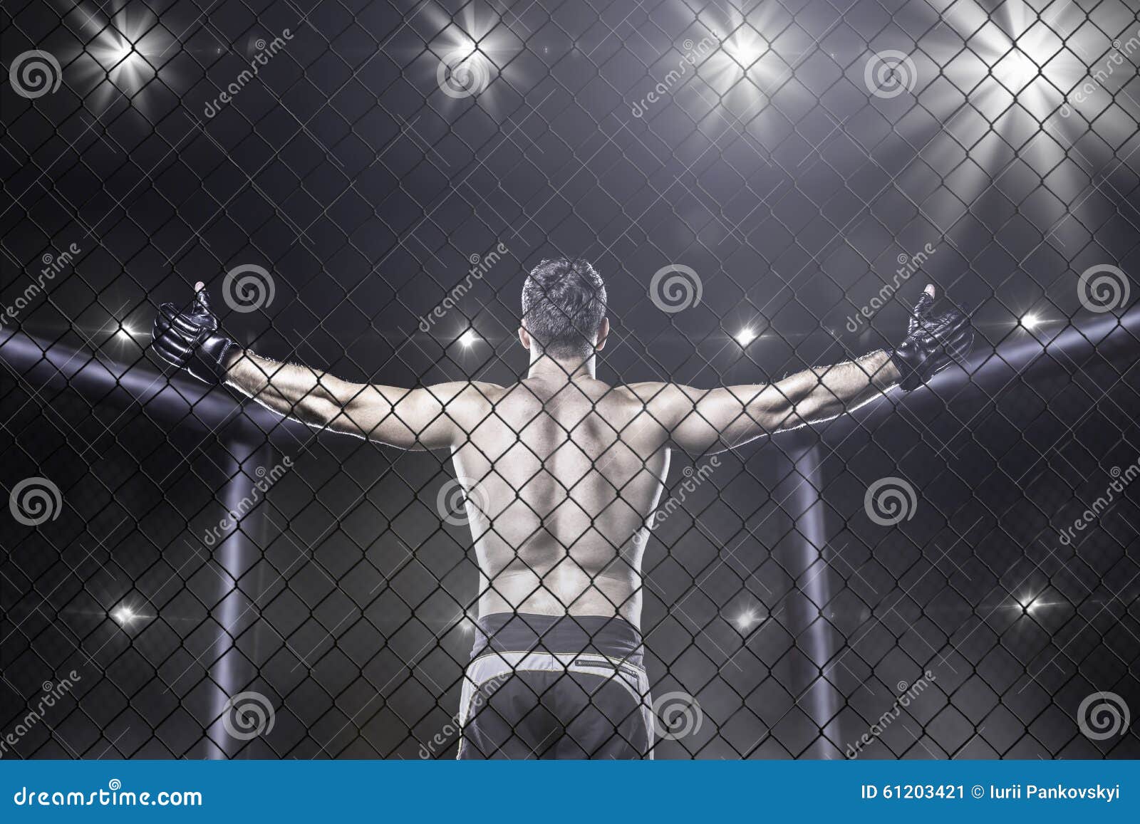 mma fighter in arena celebrating win, behind view