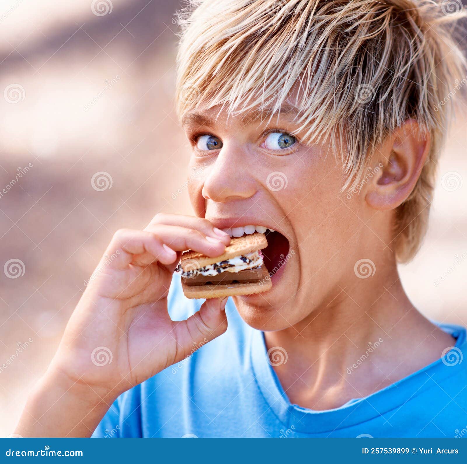 Mmmmm. Cropped View of a Little Boy Eating a Marshmallow Smore. Stock