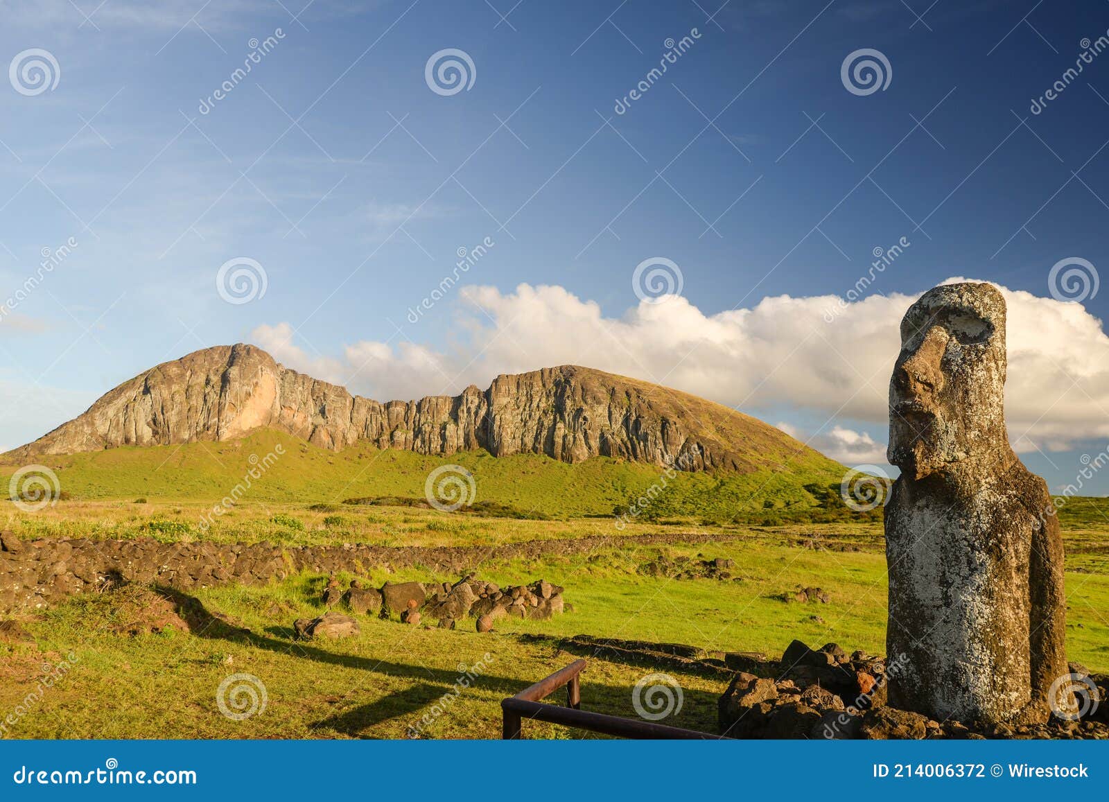 moai located at tongariki's entrance with rano raraku volcano at the background