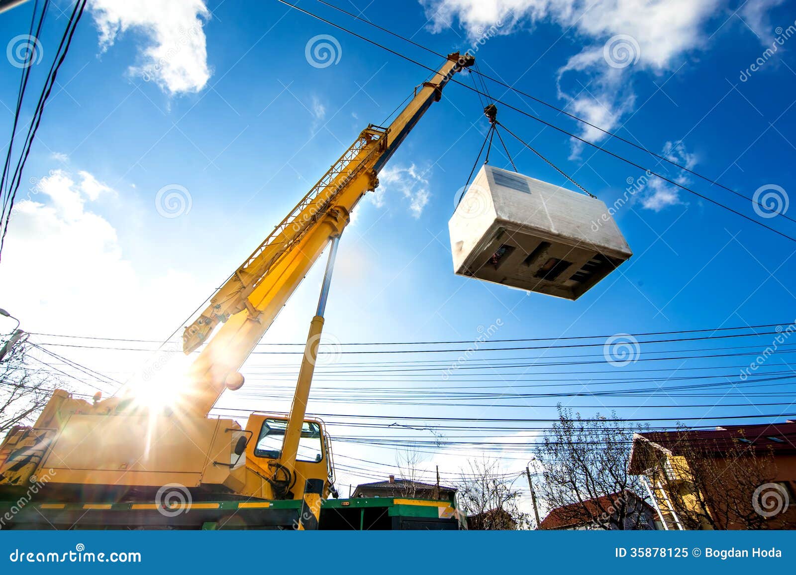 mobile crane operating by lifting an electric generator