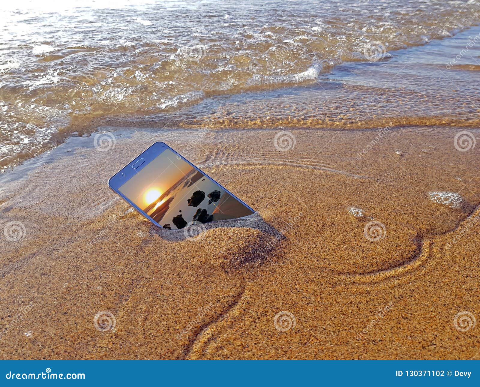 Mobile Phone Dropped into the Water from the Ocean Stock Photo Image