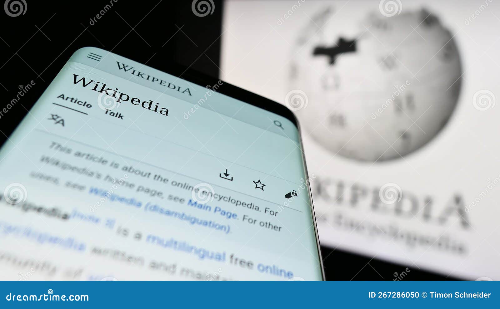 Mobile Phone with page of Online Encyclopedia Wikipedia on Screen in
