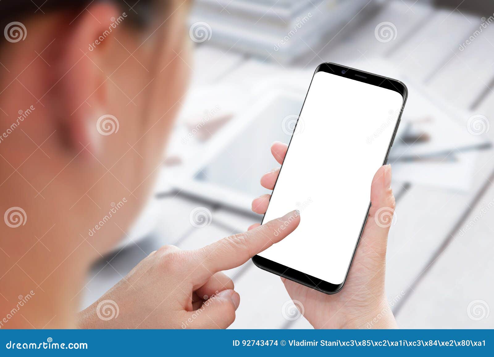 mobile phone in woman hand. left hand touch display.  screen for mockup.