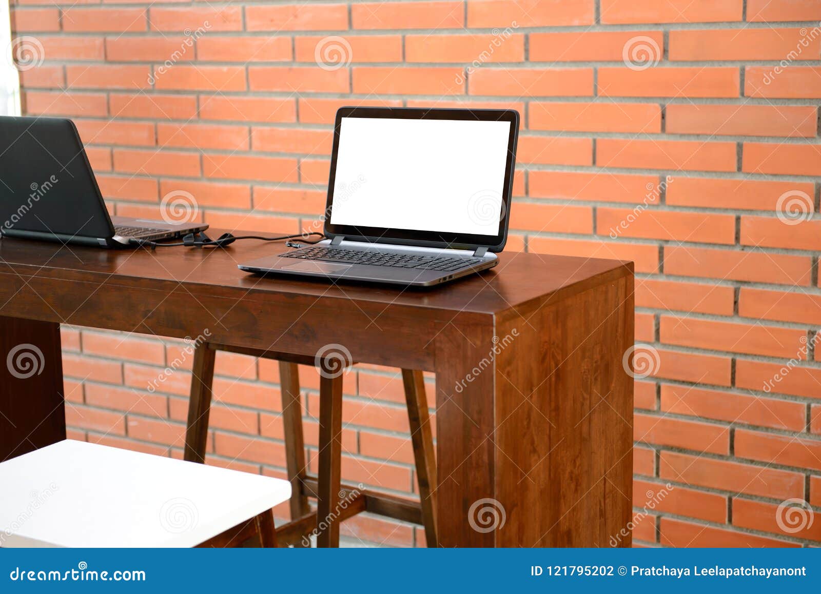 Mock Up Blank Screen Laptop On Modern Wooden Table With Bricks