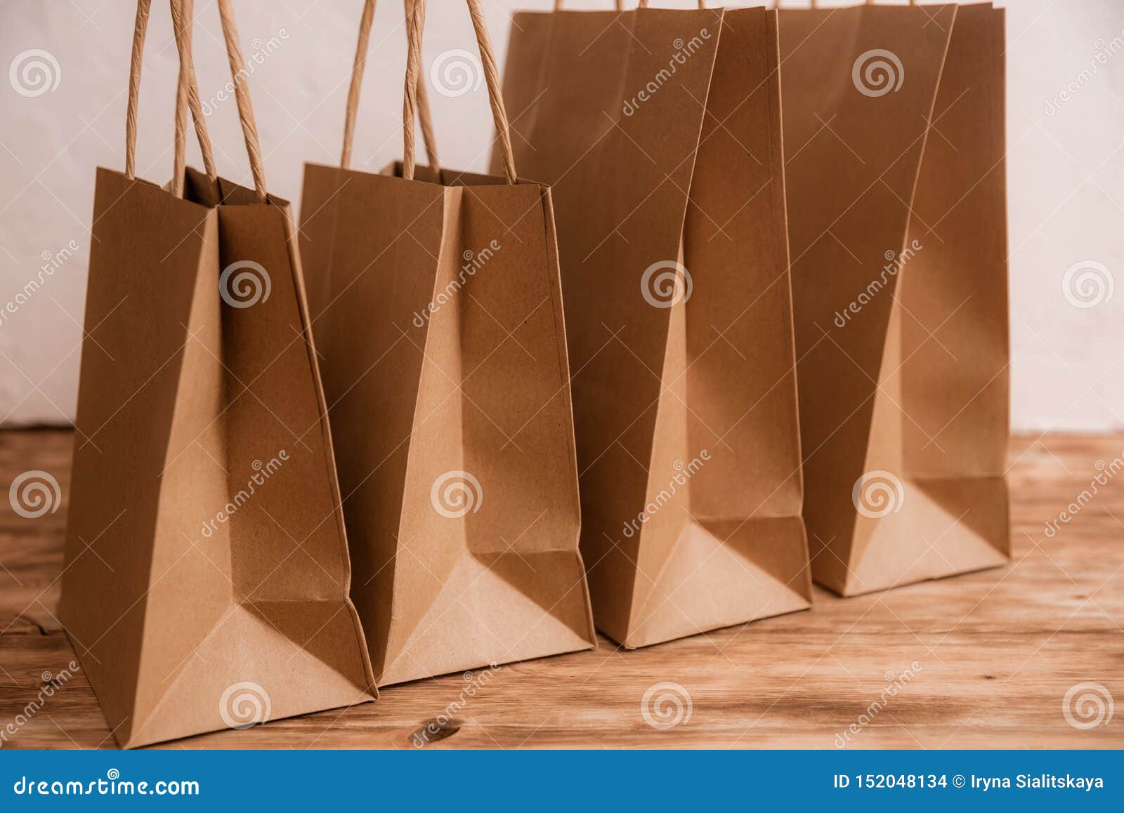 Download Mock-up Of Brown Craft Paper Package With Handles, Empty Shopping Bag With Area For Your Logo Or ...