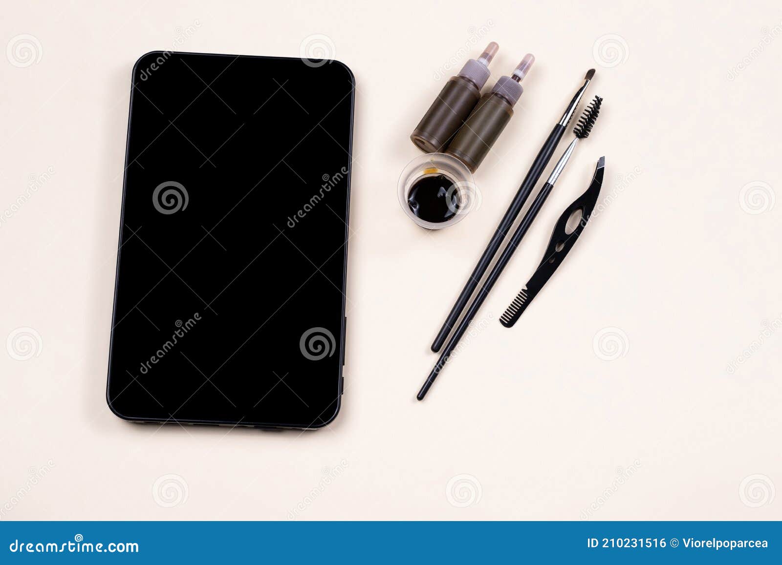 mock up empty black tablet screen near a set for brow hena, tweezing procedure. video tutorial, online fashion workshop. skincare