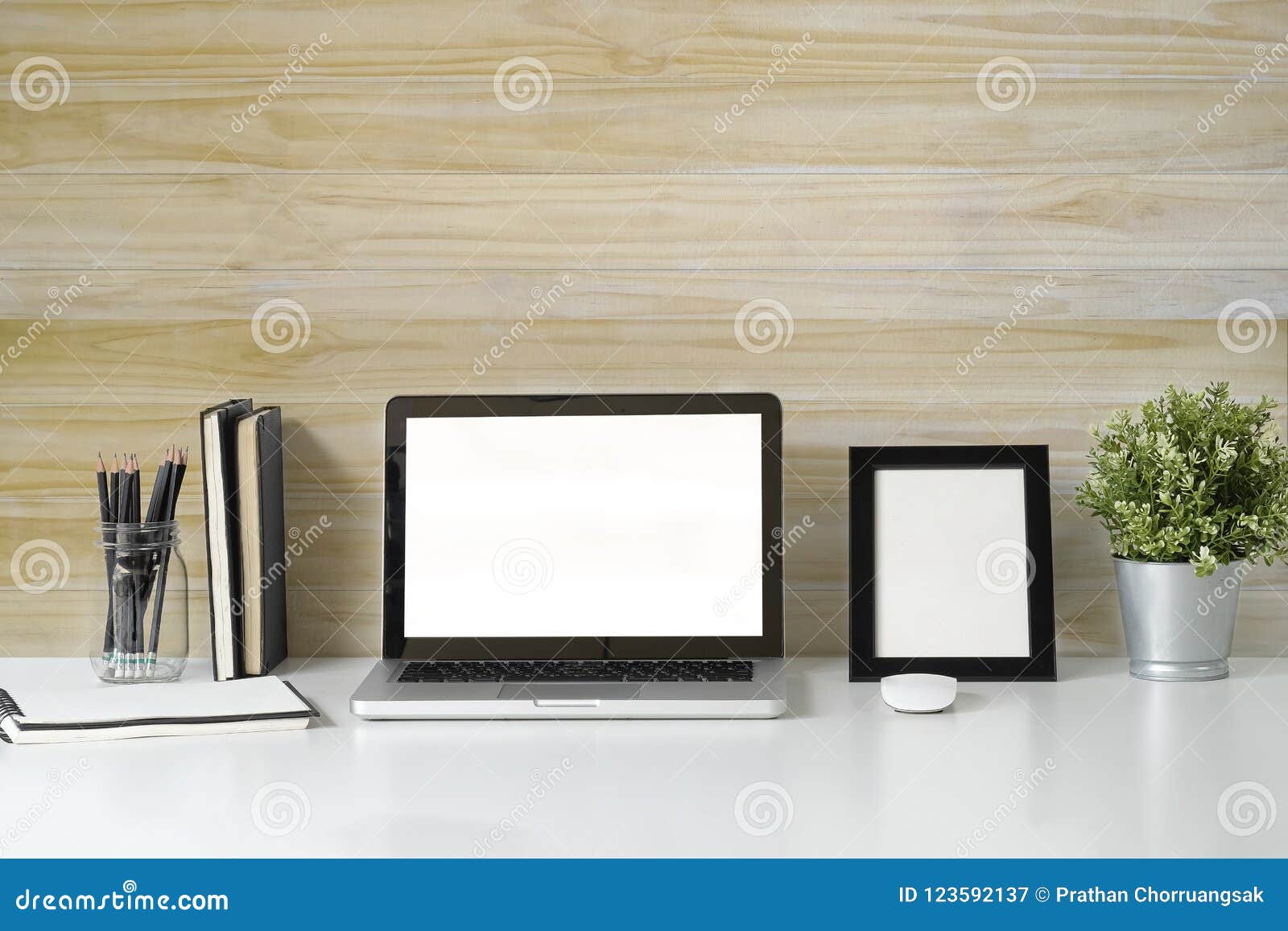 mock up laptop computer on white top desk and wooden wall with b