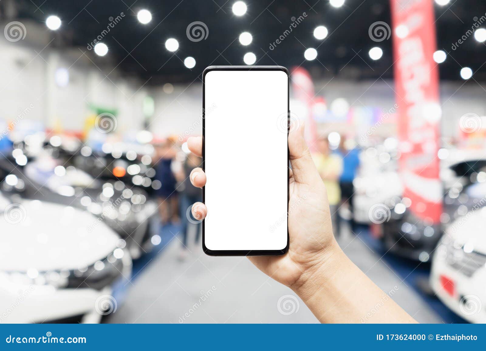 Mock Up Mobile Phone Hand Holding Mobile Phone with Abstract Blurred Cars Exhibition Show  