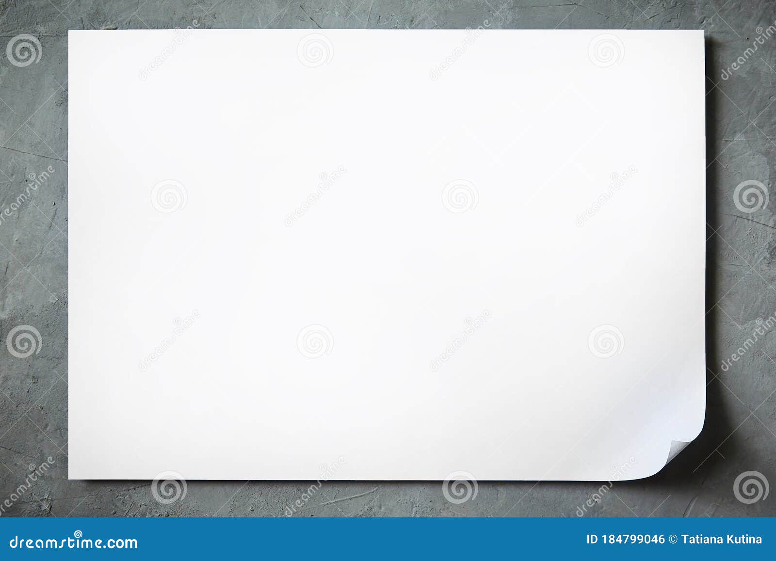 mock up of a sheet of white a4 paper with a bent corner and shadow on a concrete background