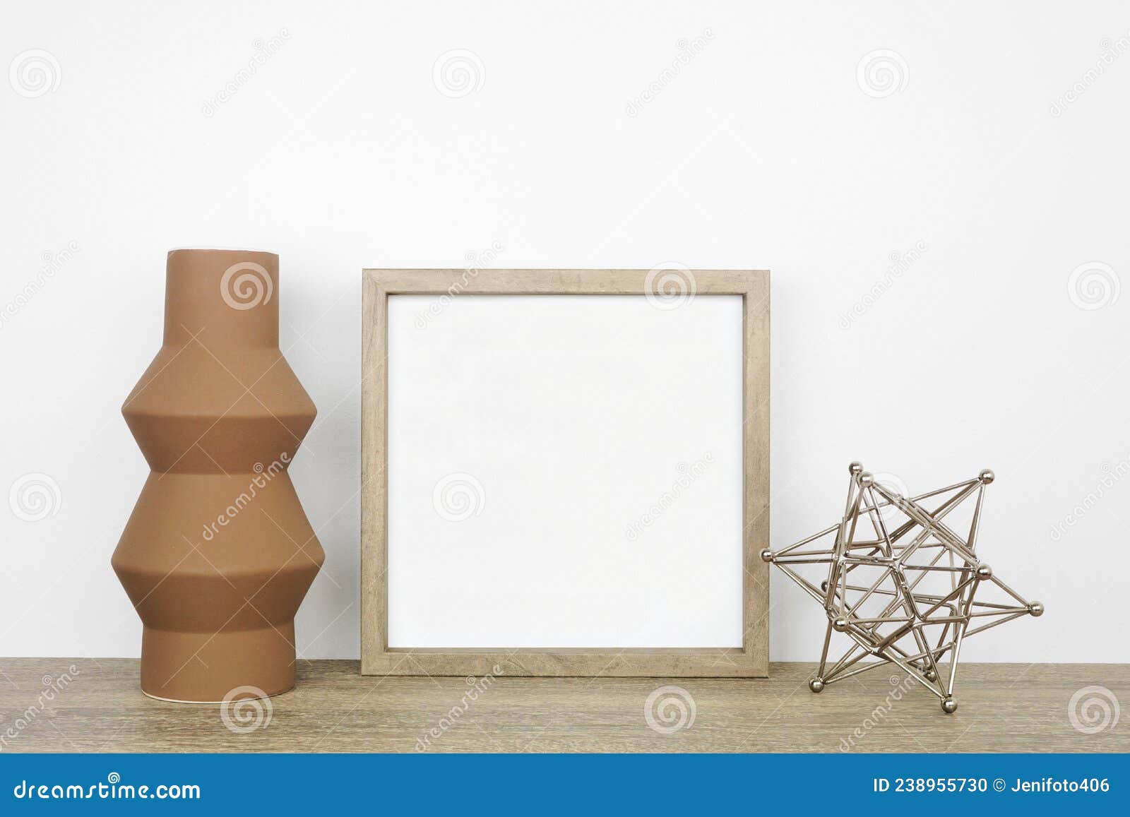 mock up wood square frame with modern home decor on a wood shelf against a white wall
