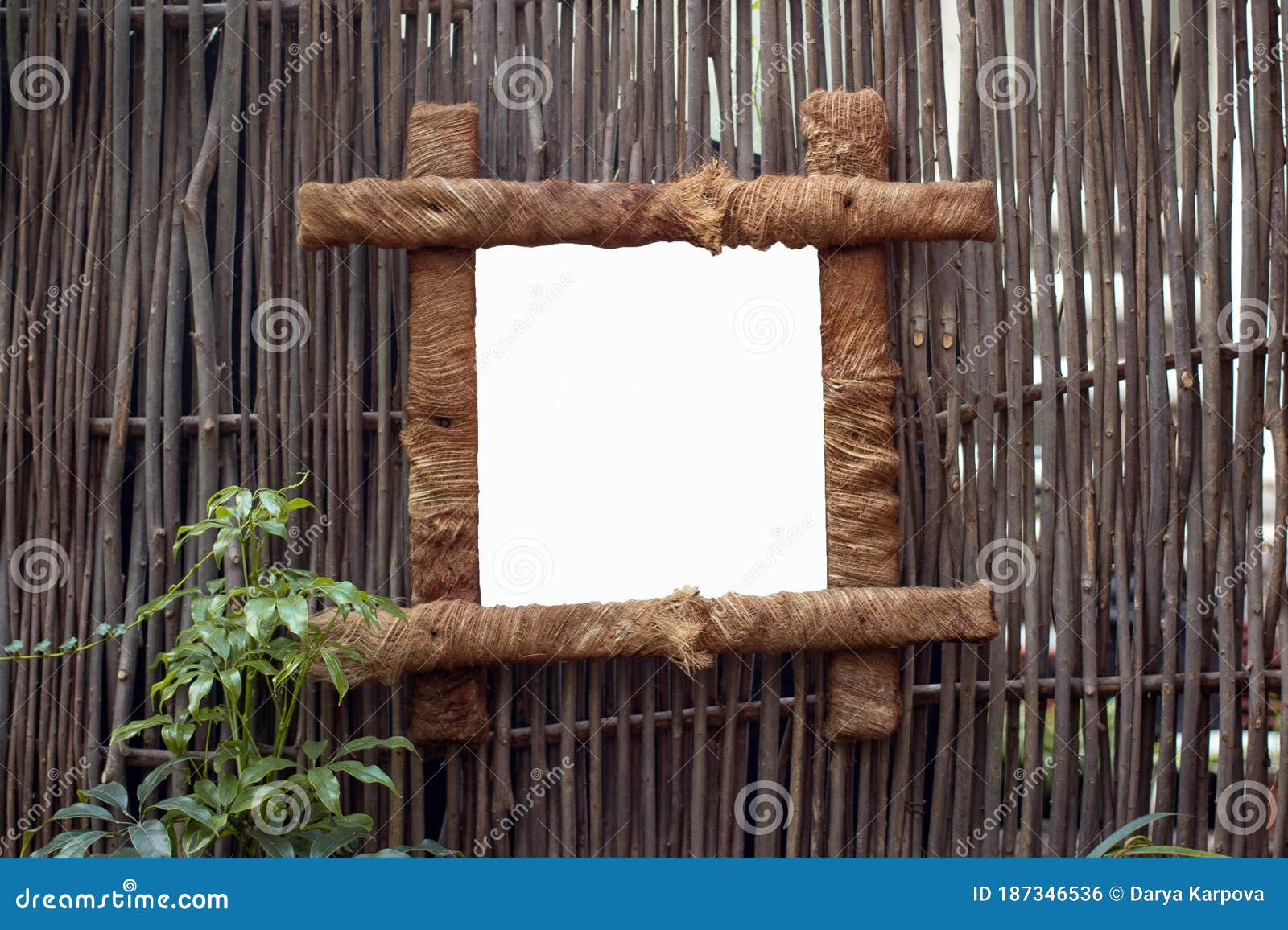 Mock Up. Wooden Frame Hanging on the Rods in the Tropics Stock Photo