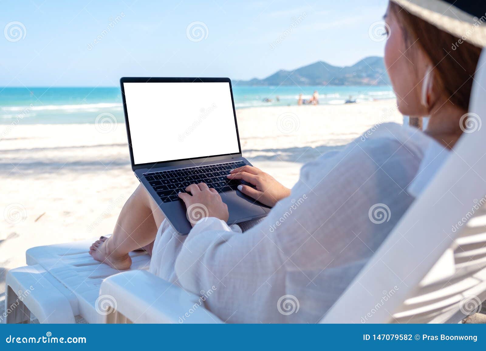 A Woman Using And Typing On Laptop Computer With Blank Desktop