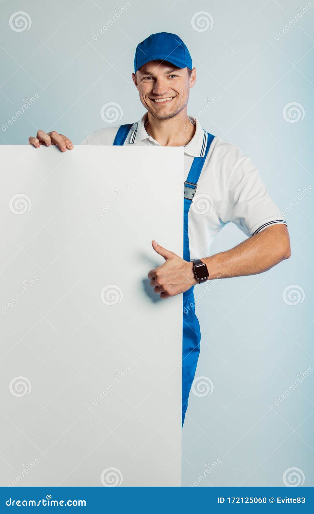 Download Mockup Of Smiling Young Worker Man Wearing Blue Uniform ...