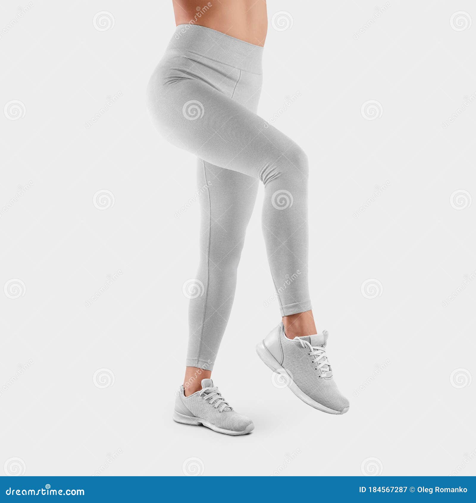 Woman in white tights and sneakers on gray background Stock