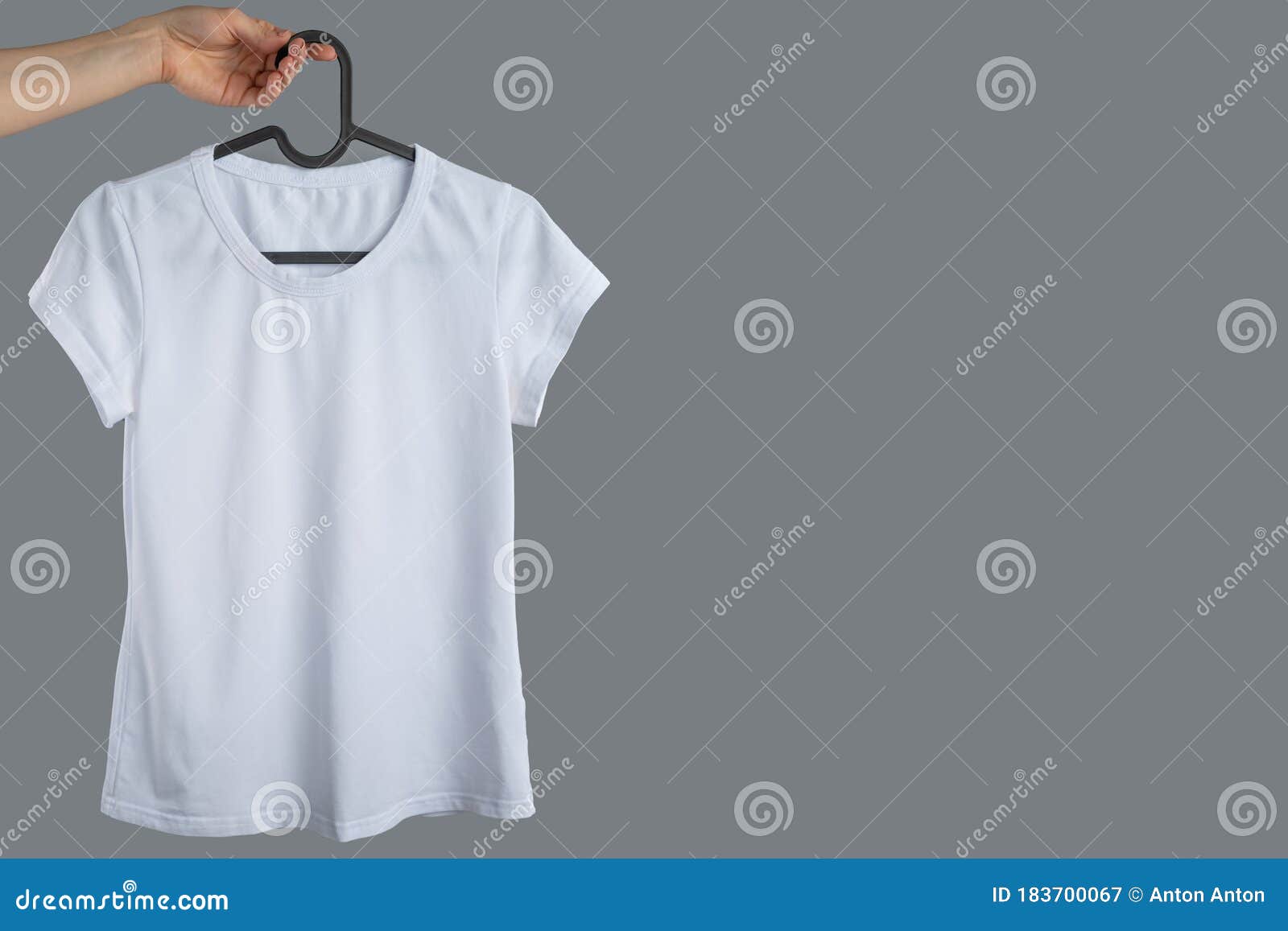 Download Mockup White T Shirt Space For Design Brands And Logos Female Hand Holds A Hanger With A White T Shirt On A Gray Background Stock Image Image Of Gray Color 183700067