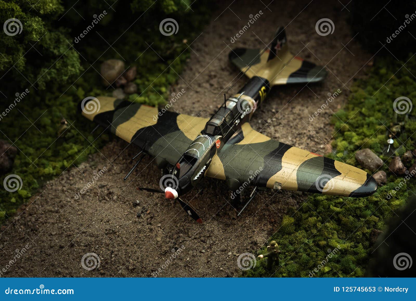 model of airplane il-2 with soldiers in diorama