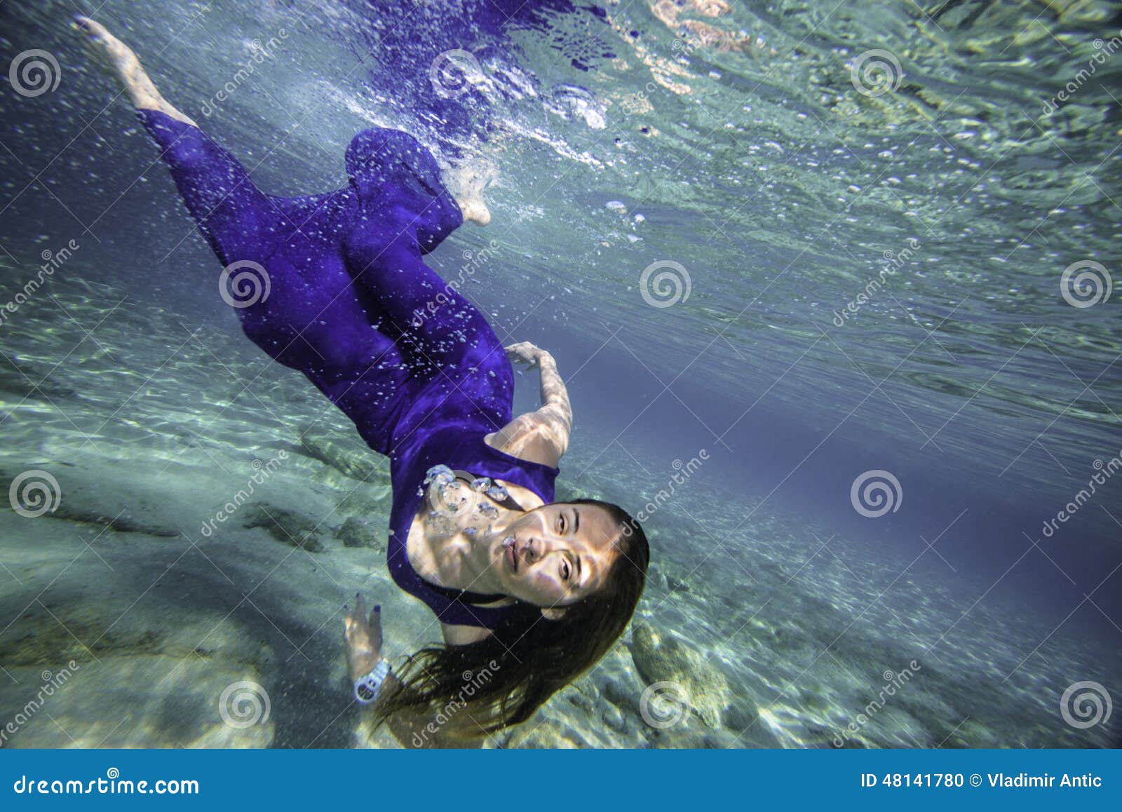 Model in blue dress diving stock photo. Image of deep 48141780
