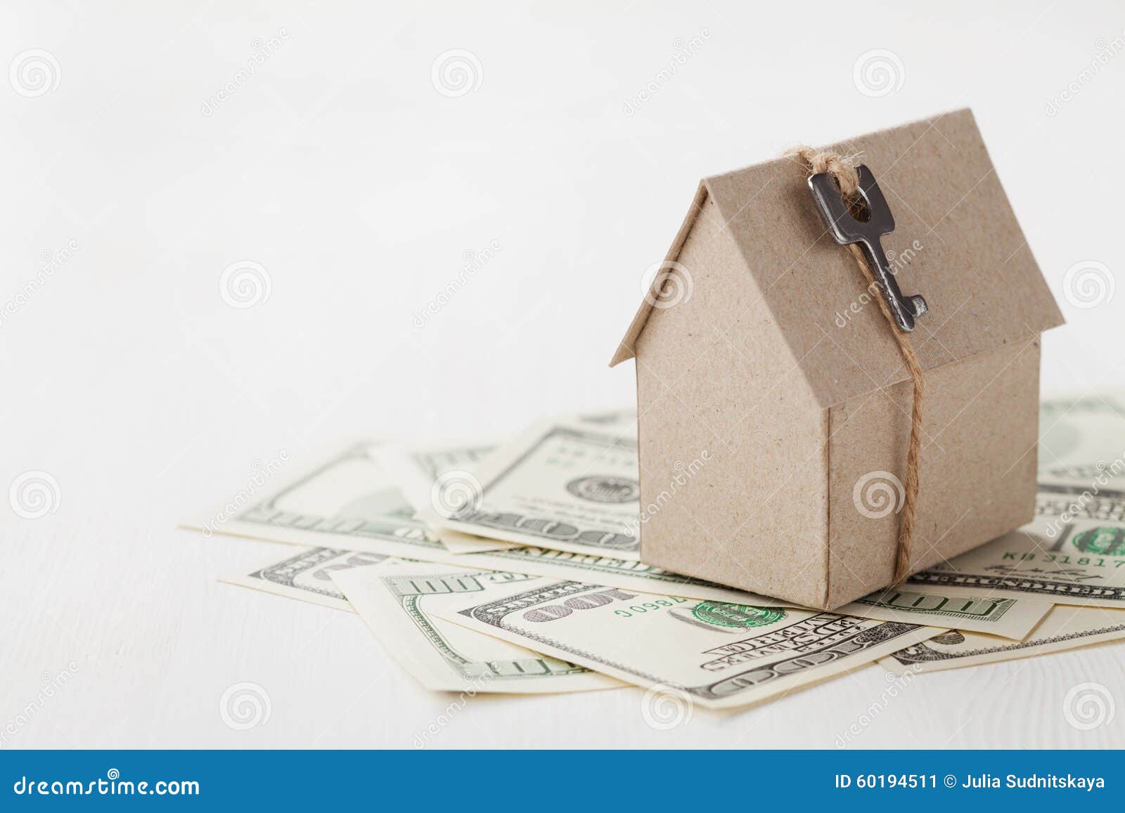 model of cardboard house with key and dollar bills. house building, loan, real estate, cost of housing or buying a new home concep