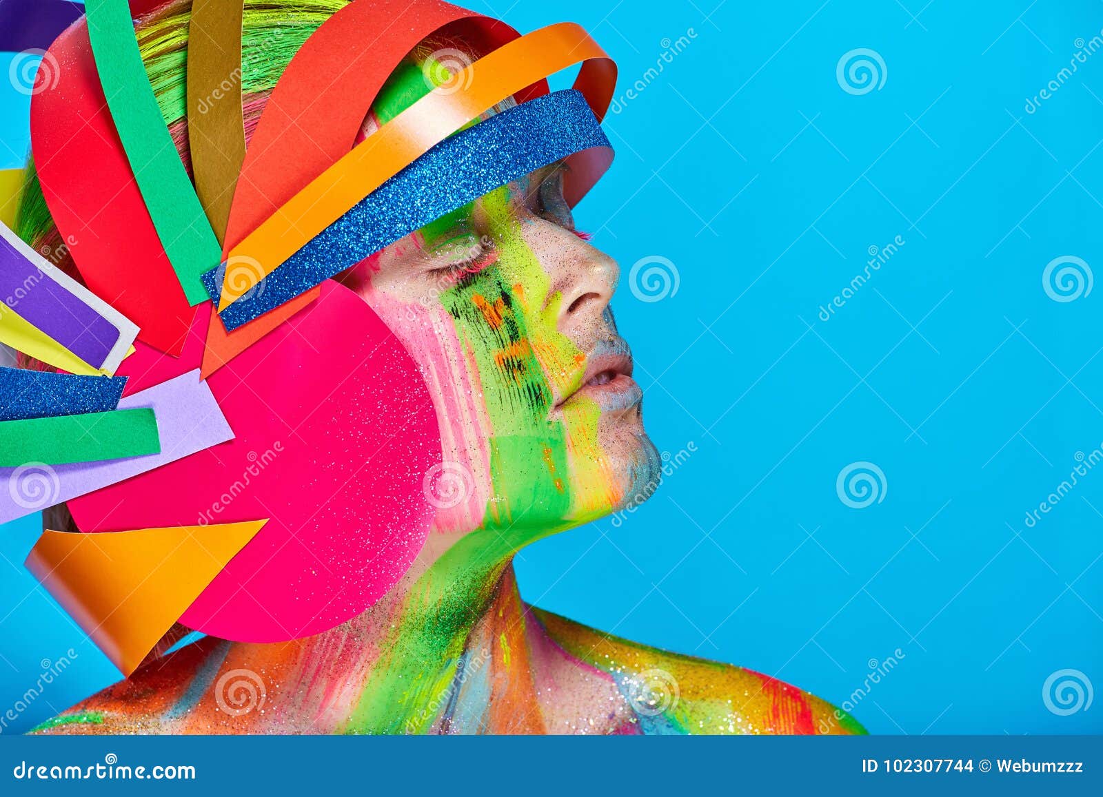 model with colorful abstract makeup in multicolored helmet