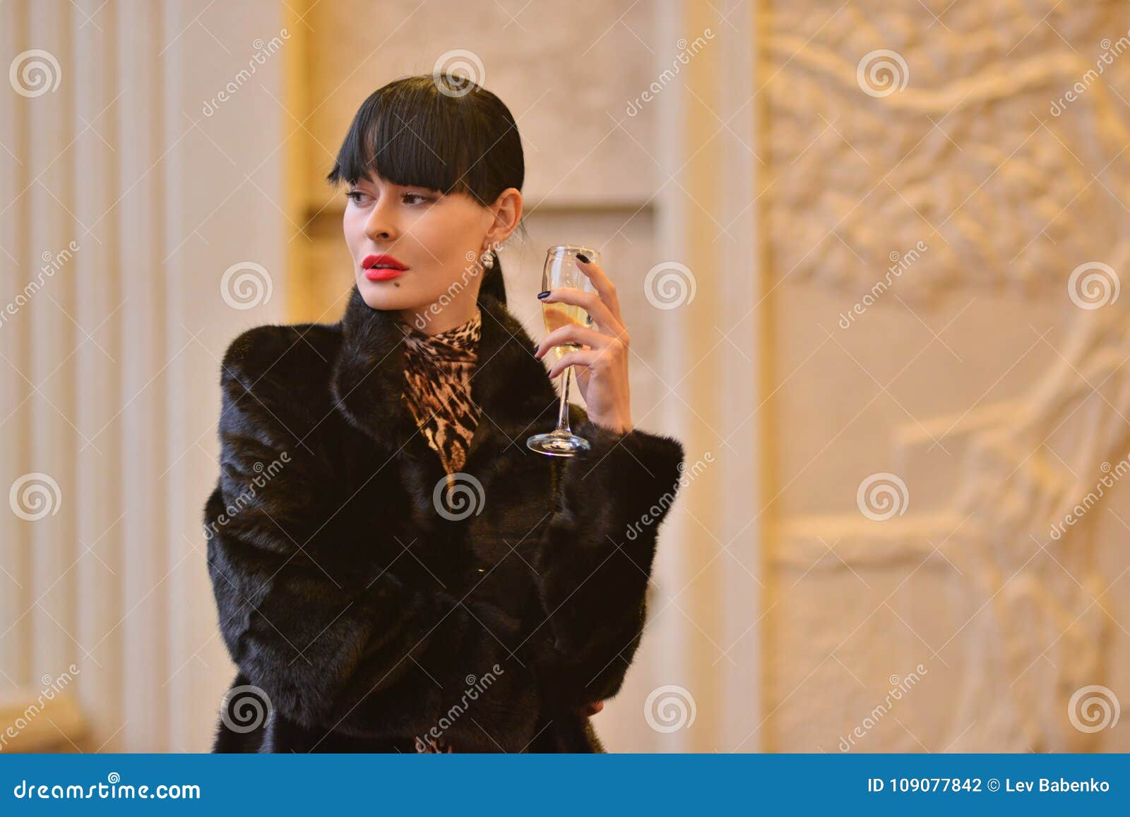 Model in an Expensive Black Sheepskin Coat Posing in a Restaurant Stock