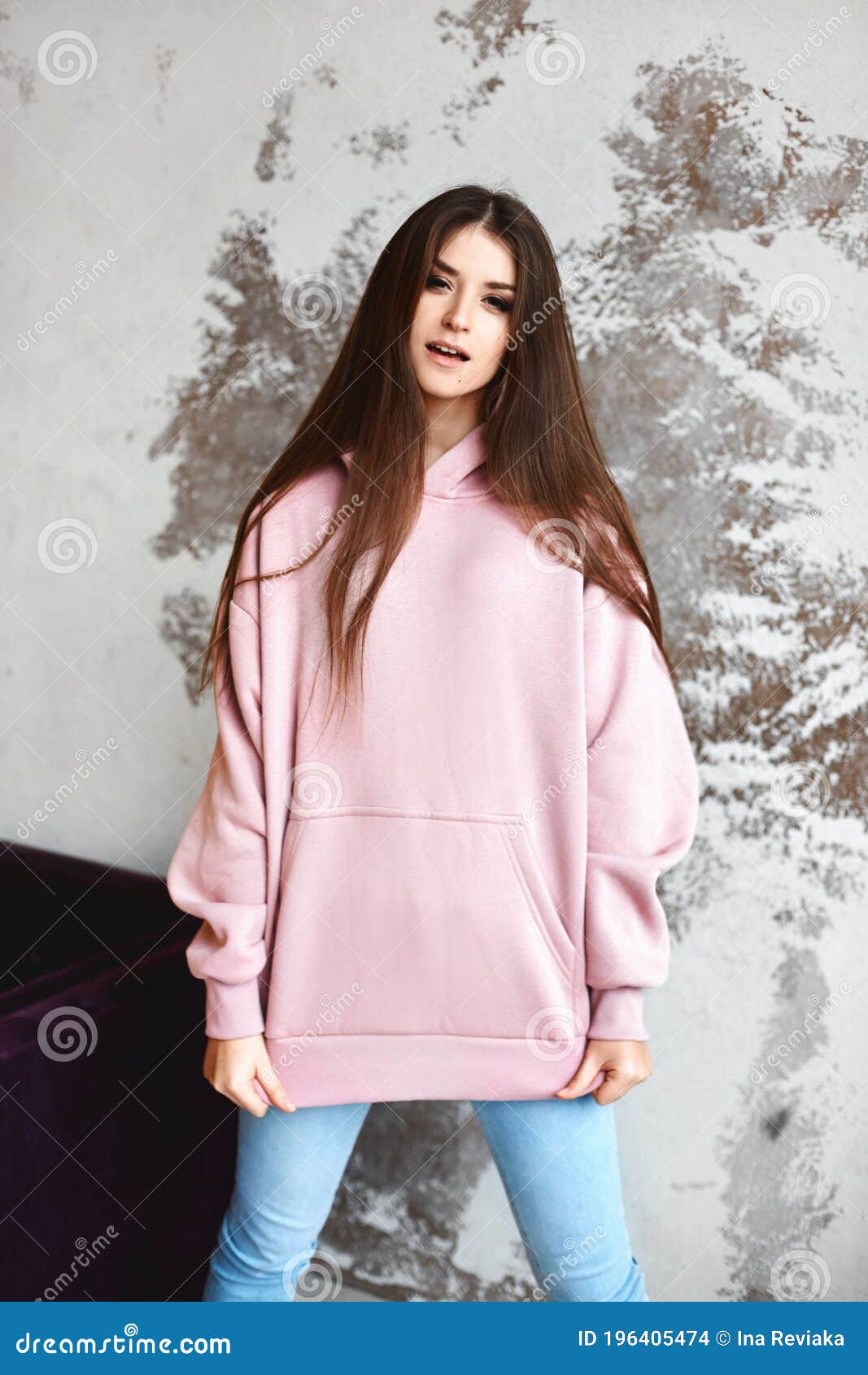 Model Girl in a Pink Blank Hoodie and Blue Jeans Looking in Camera ...