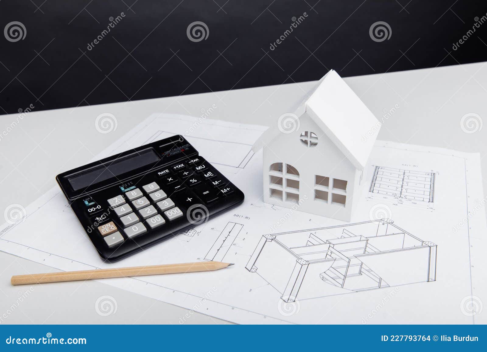 Model of House and Calculator on Architectural Project. House Building