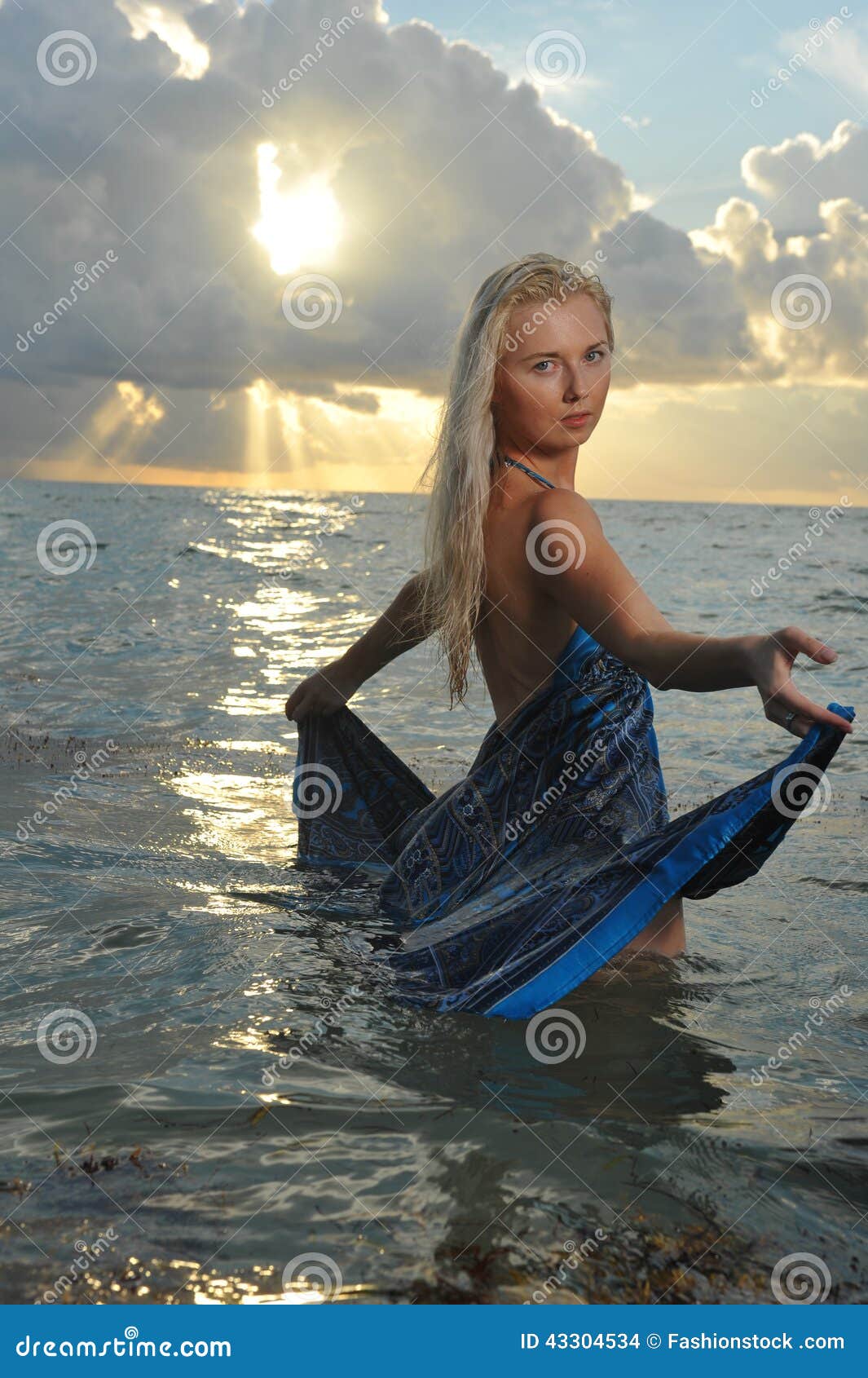 Model Posing In Beach Dress At Early Morning Sunrise Stock ...