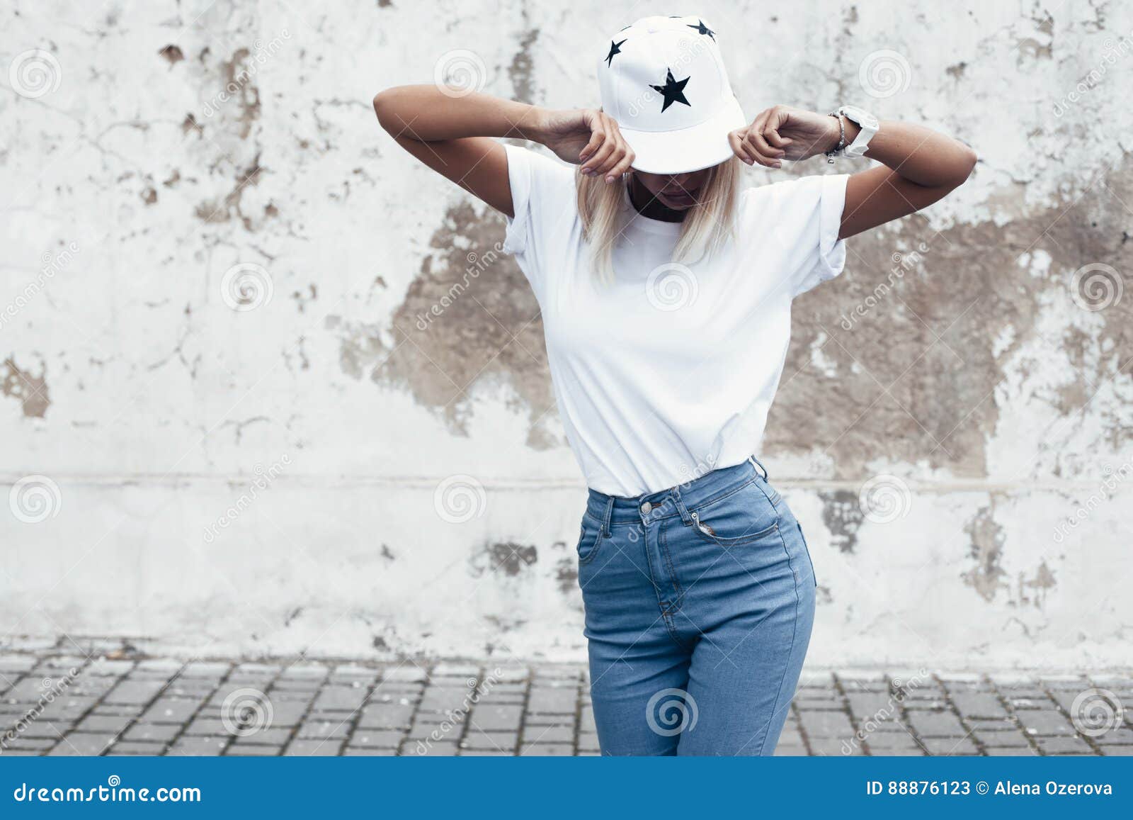 model posing in plain tshirt against street wall