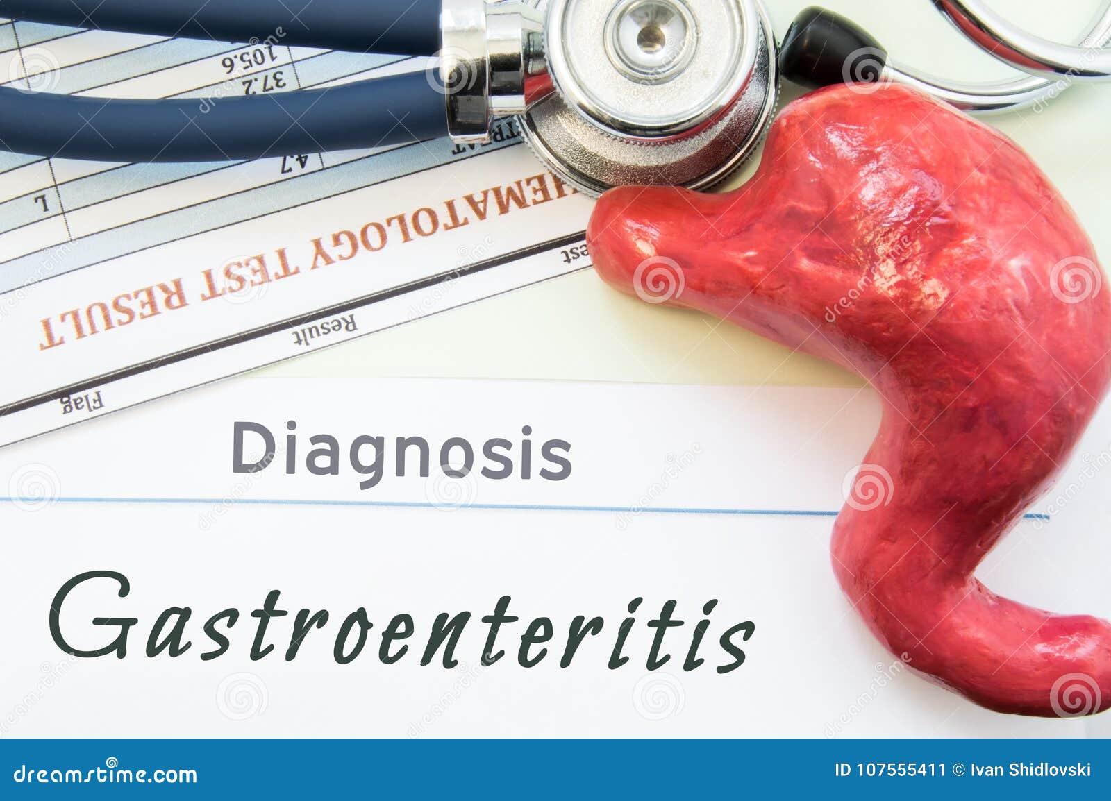 model of stomach, blood test and stethoscope lying next to written title on paper diagnosis gastroenteritis. concept photo of caus