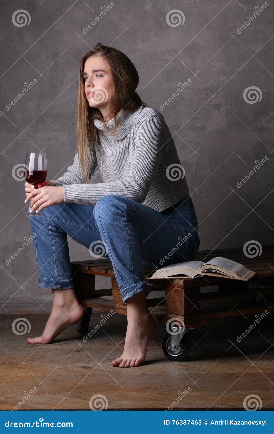 Model In Sweater And Jeans Holding Wineglass Gray 
