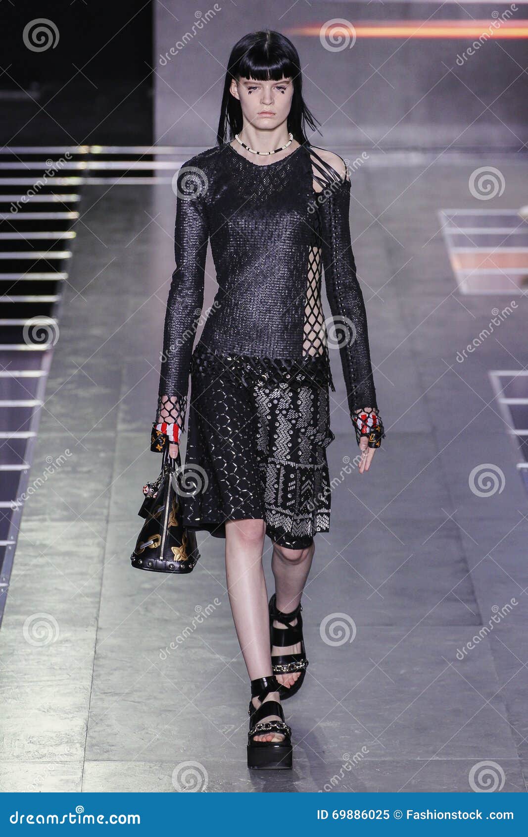 A model walks on the runway at the Louis Vuitton fashion show