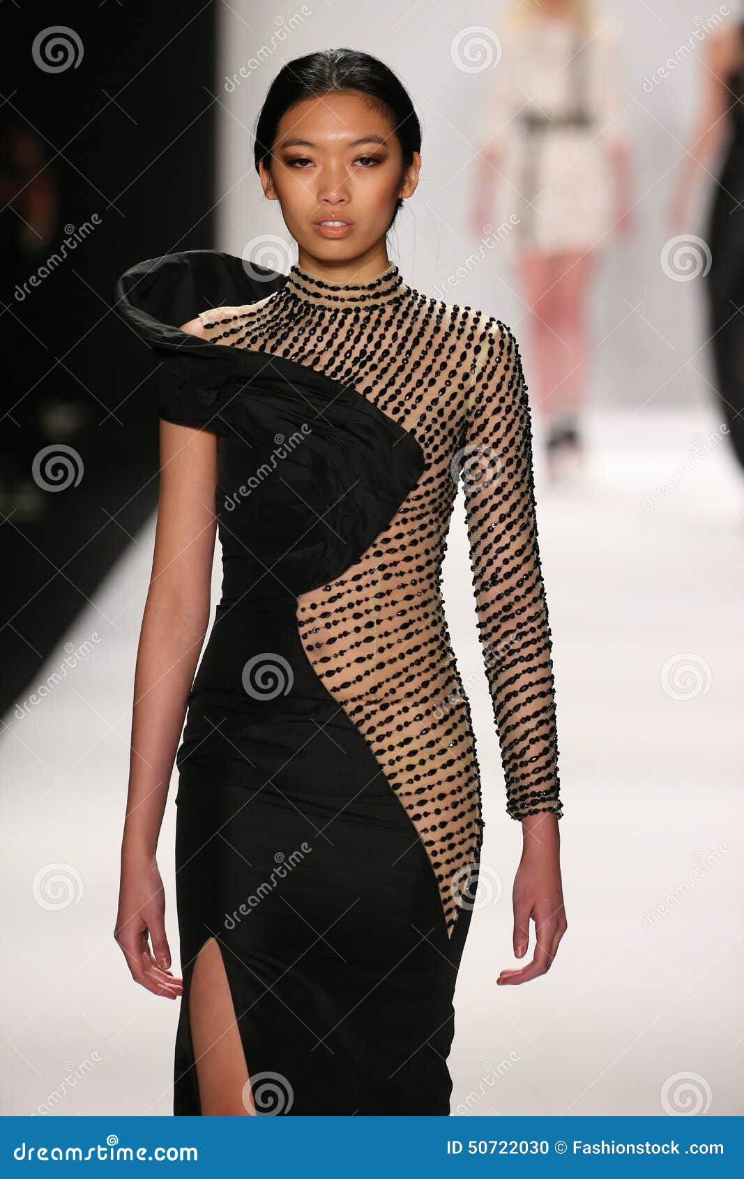 A Model Walks the Runway in a Mimi Tran Design at the Art Hearts ...