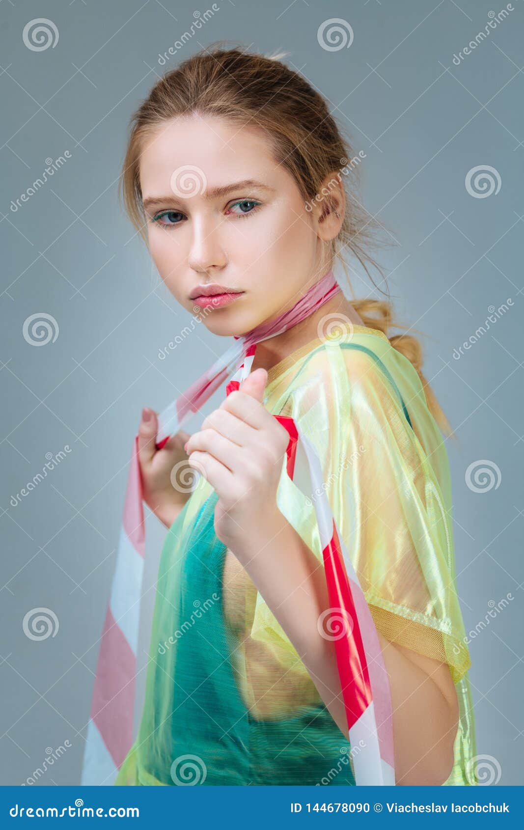 model wearing plastic coat posing with strip on neck
