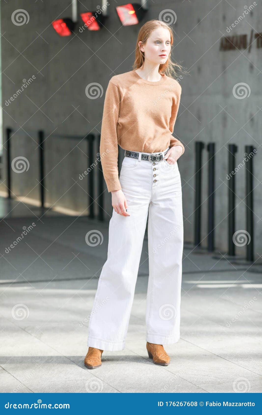 Model Wears White Jeans and a Brown Long-sleeved Shirt during the