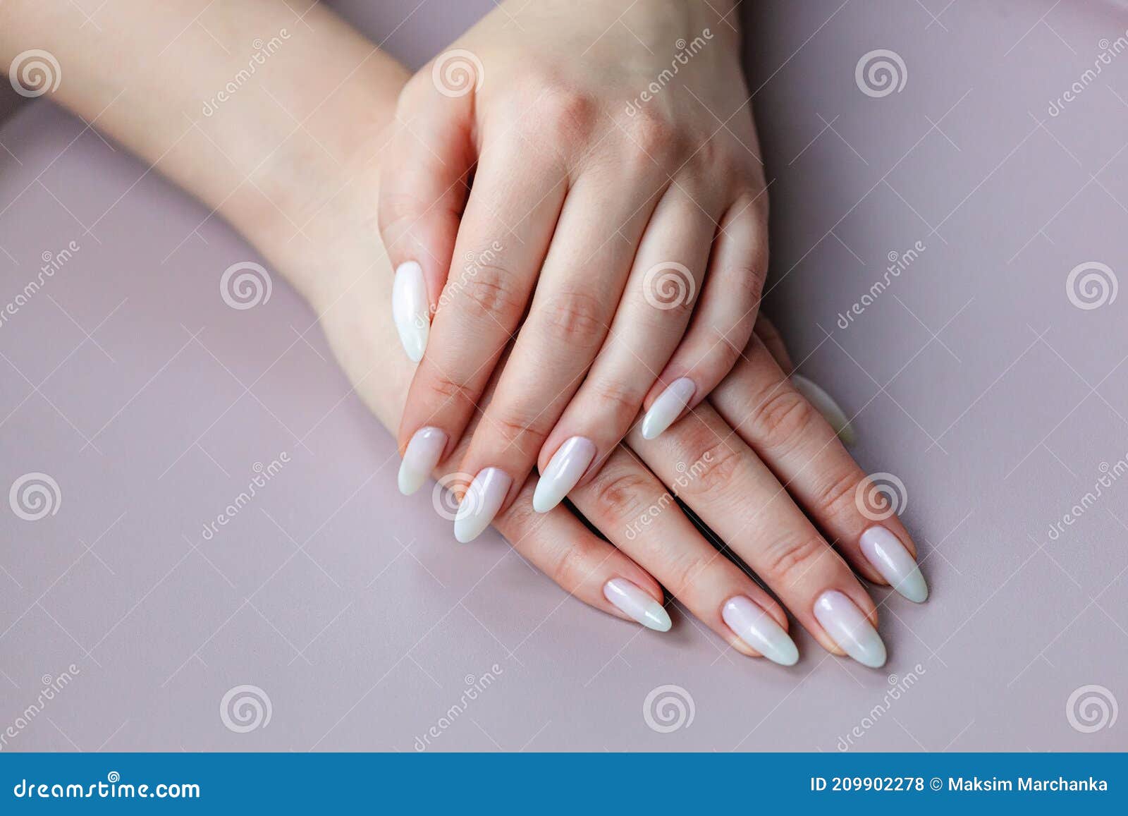 model woman showing .light white nude shellac manicure on long n