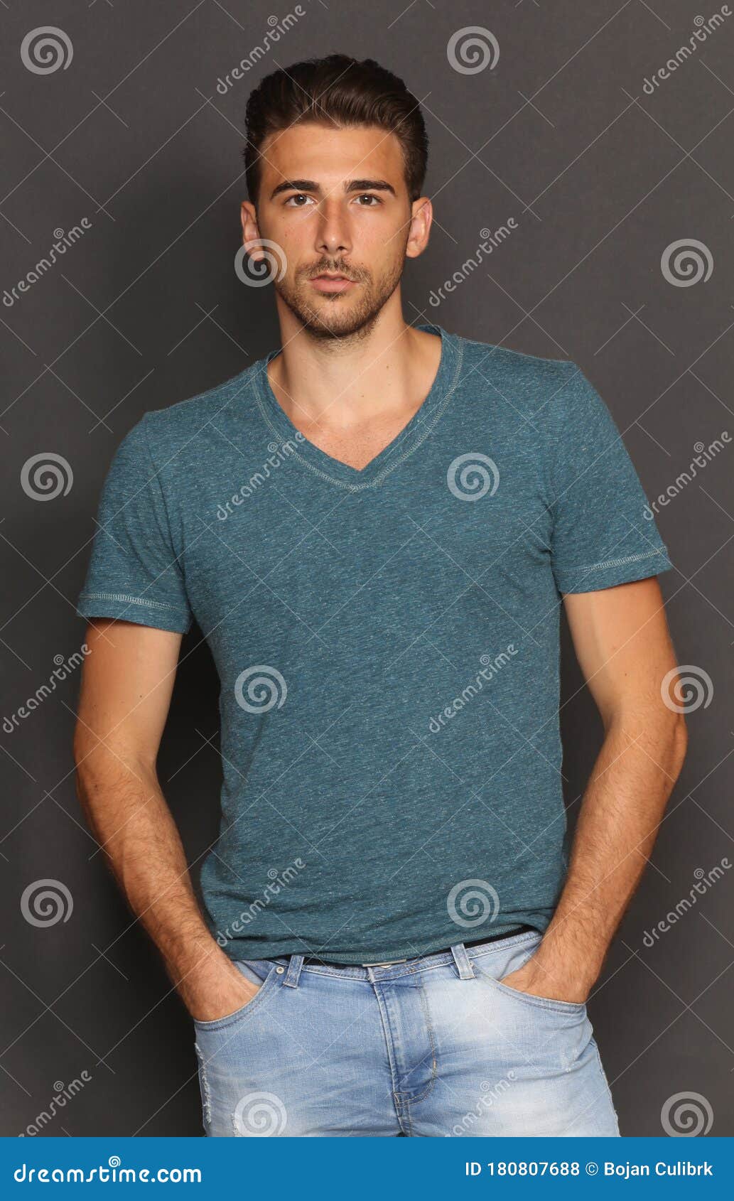 Attractive Young Tanned Male Model with Short Hair Posing in Studio on ...