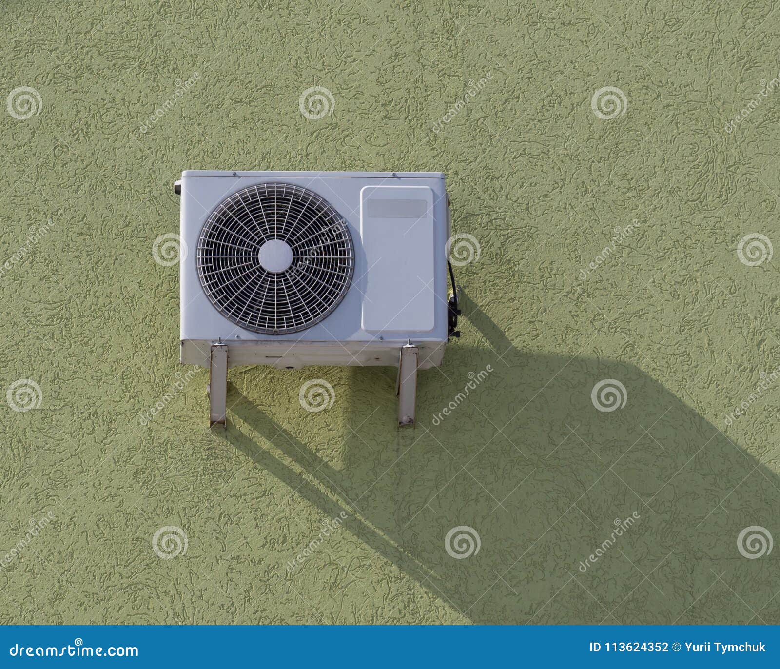 Modern Air Conditioner Outdoor on the Wall in the Sunlight Stock Photo
