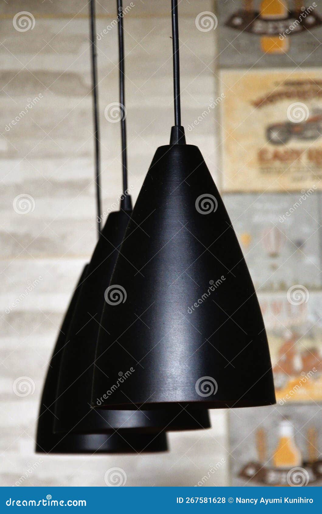 modern black domes hanging from the ceiling illuminating and decorating the kitchen