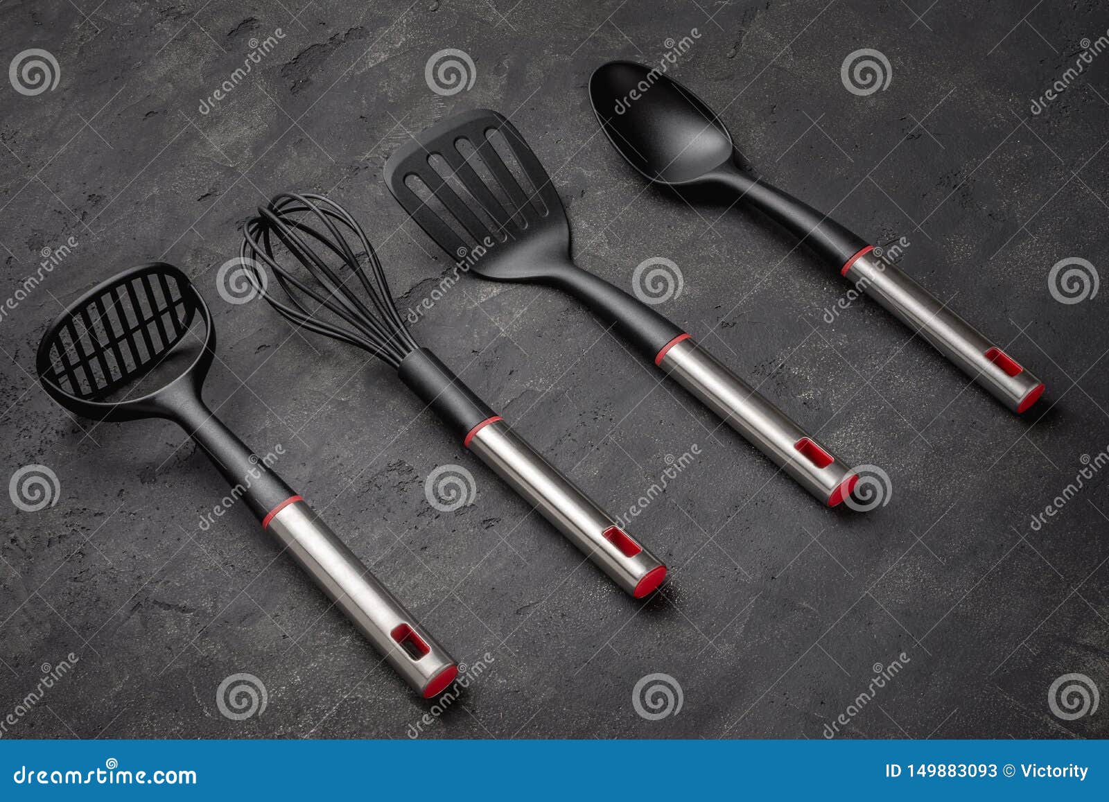 Modern Black Plastic Kitchen Utensils on Dark Background Stock Image