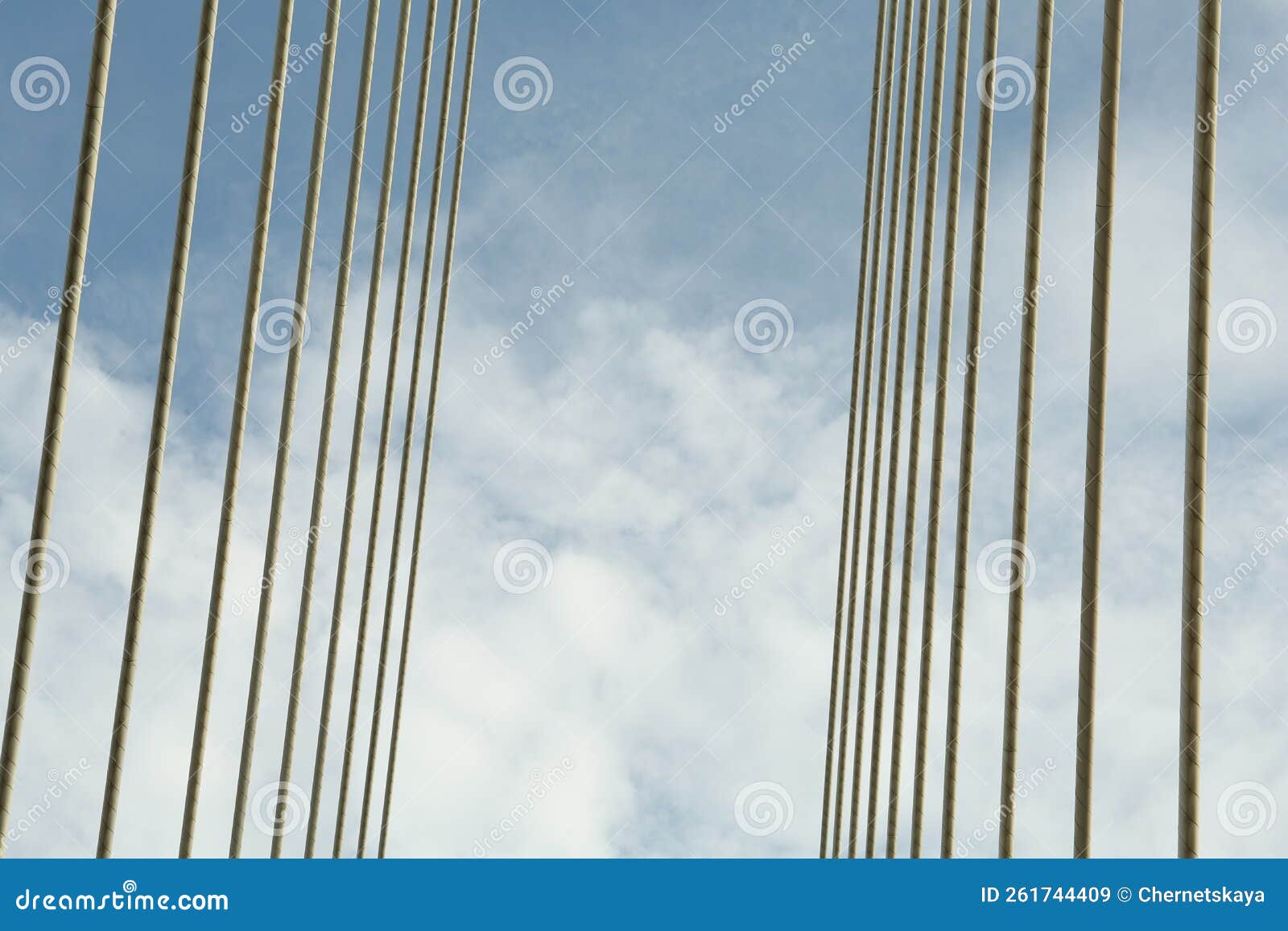 modern bridge cables against blue sky, low angle view