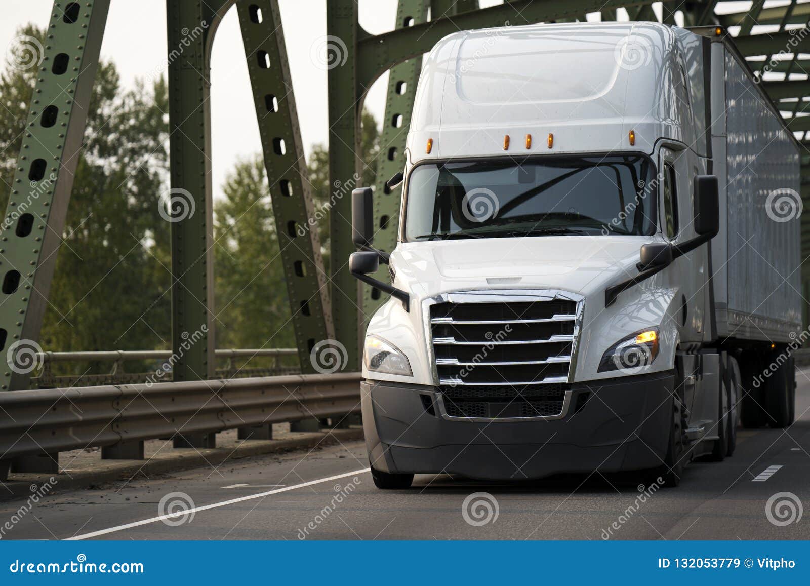 Modern Bright White Big Rig Semi Truck With Semi Trailer Moving Stock