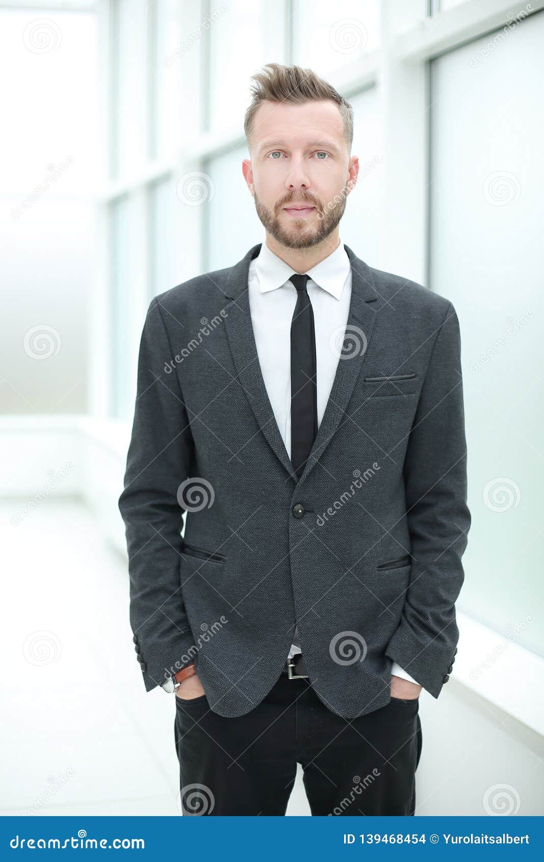 Modern Business Man Standing in a Bright Office. Stock Photo - Image of ...