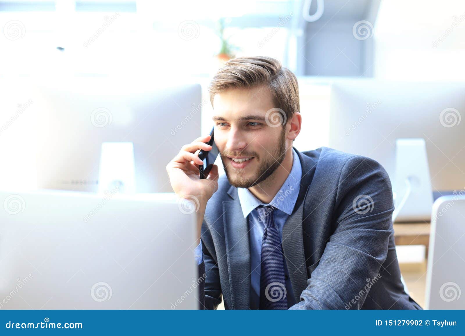 Modern Businessman Analyzing Data Using Computer and Talking on the ...