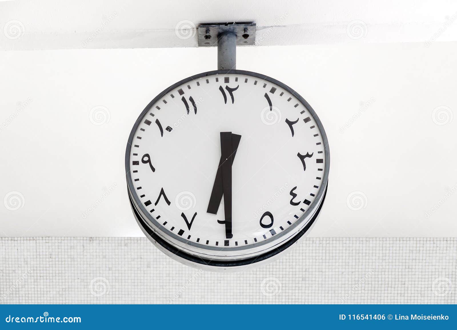 modern clock round  with arabic circulars on dial and hands, showing the time 6: 30.