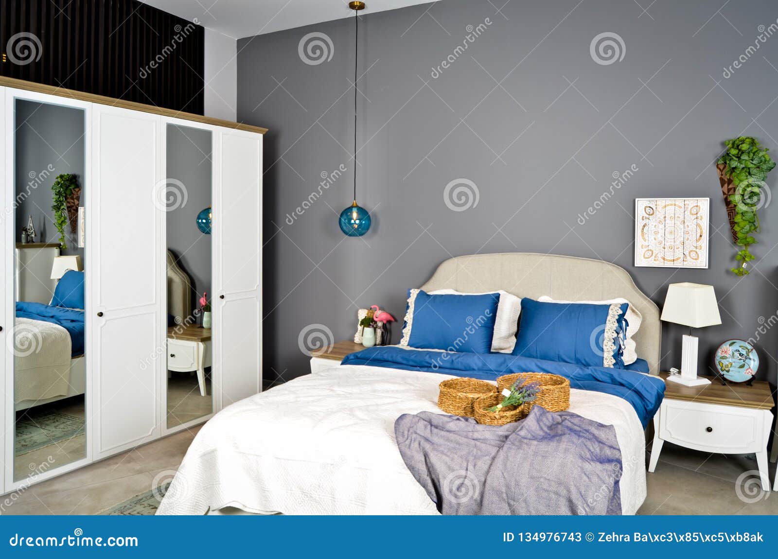 In A Modern Bedroom Bed Pillows And Bedside Lamps Stock Image