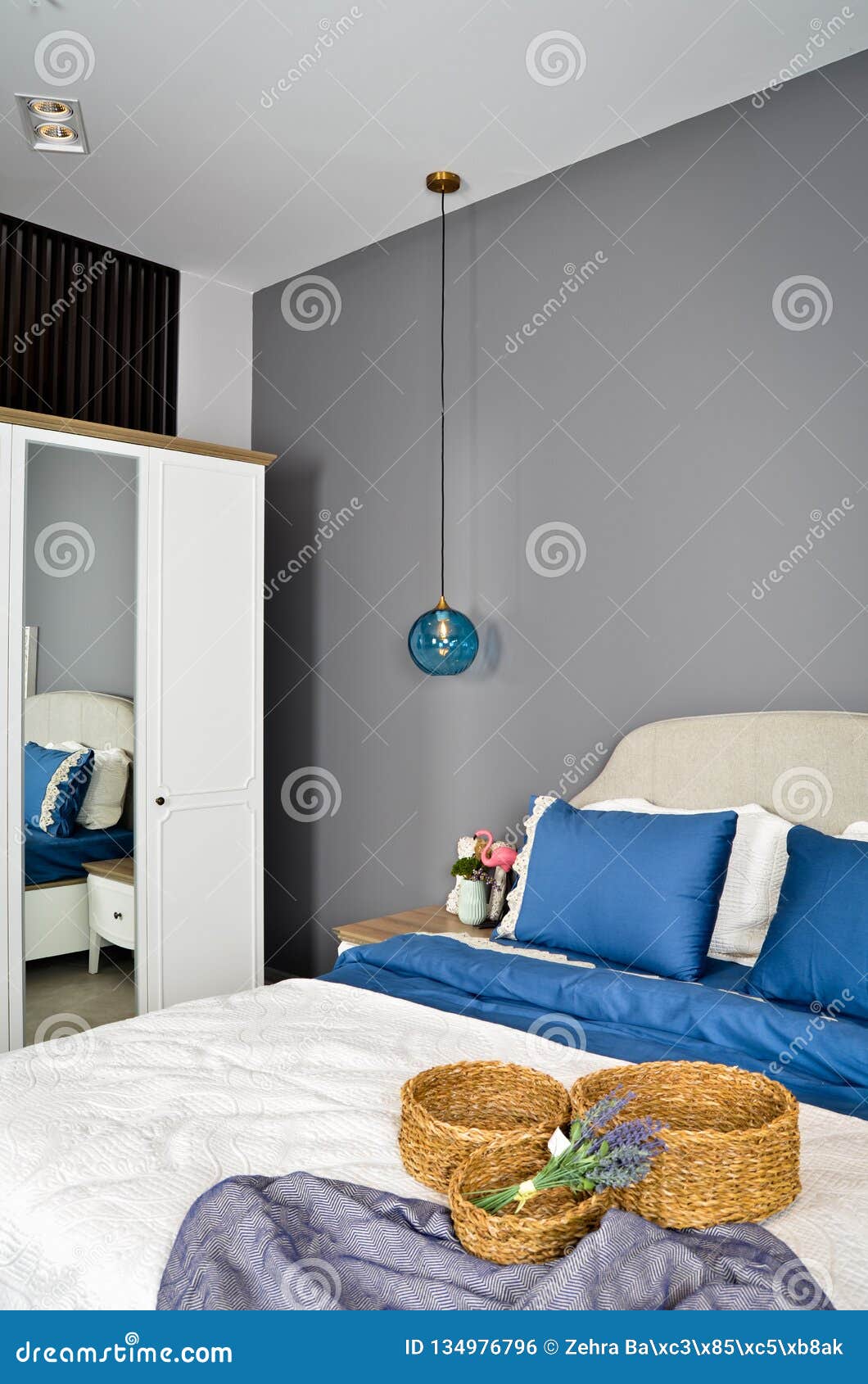 In A Modern Bedroom Bed Pillows And Bedside Lamps Stock Photo