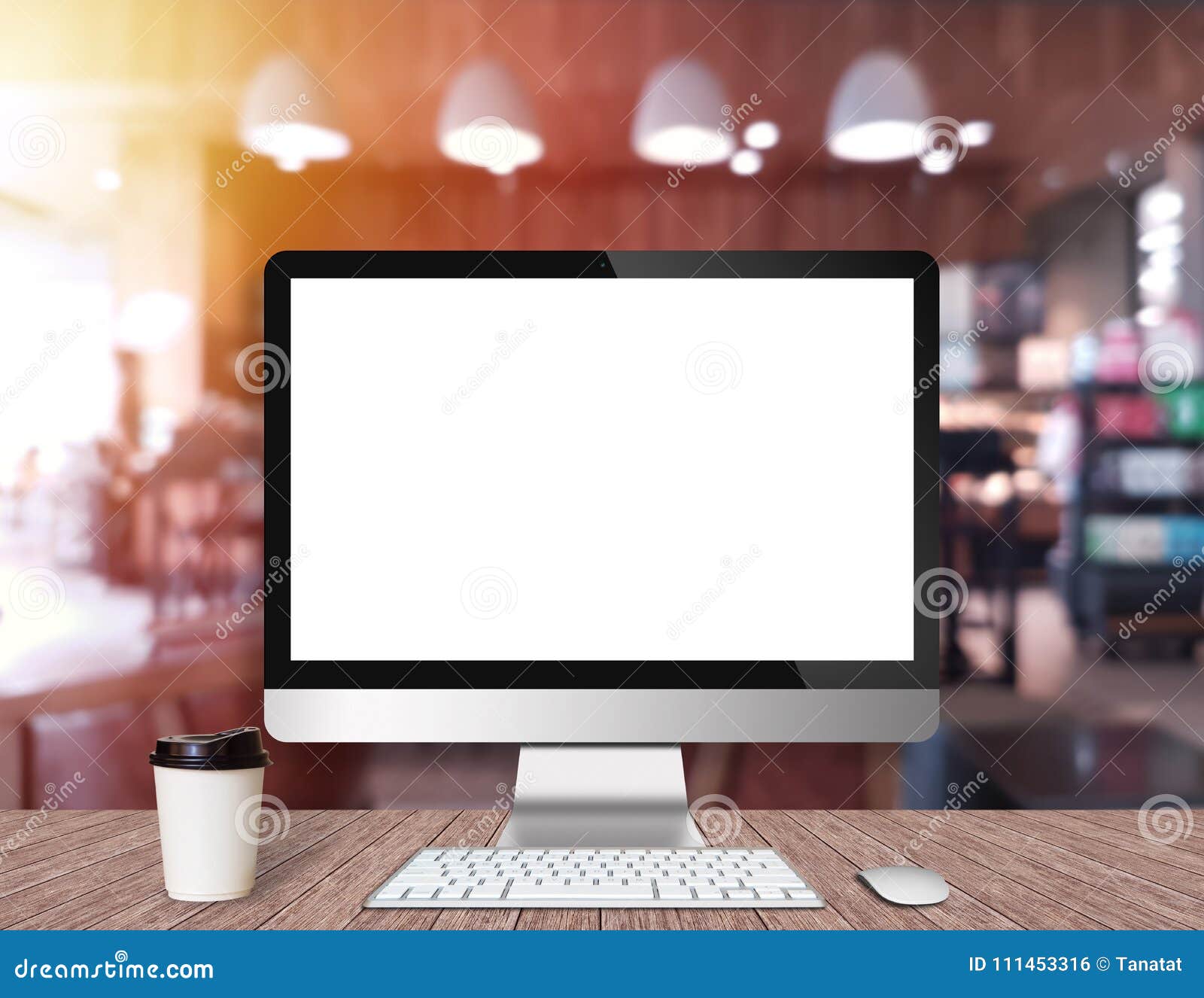 Modern Computer Monitor on a Wooden Desk with Coffee Shop Stock Photo